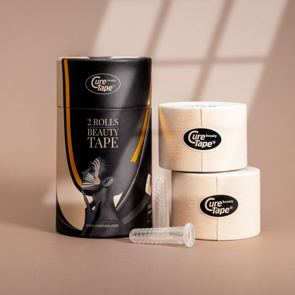 Two rolls of CureTape Beauty 5 cm tape roll for non-invasive face lifting and wrinkle reduction on a beige background