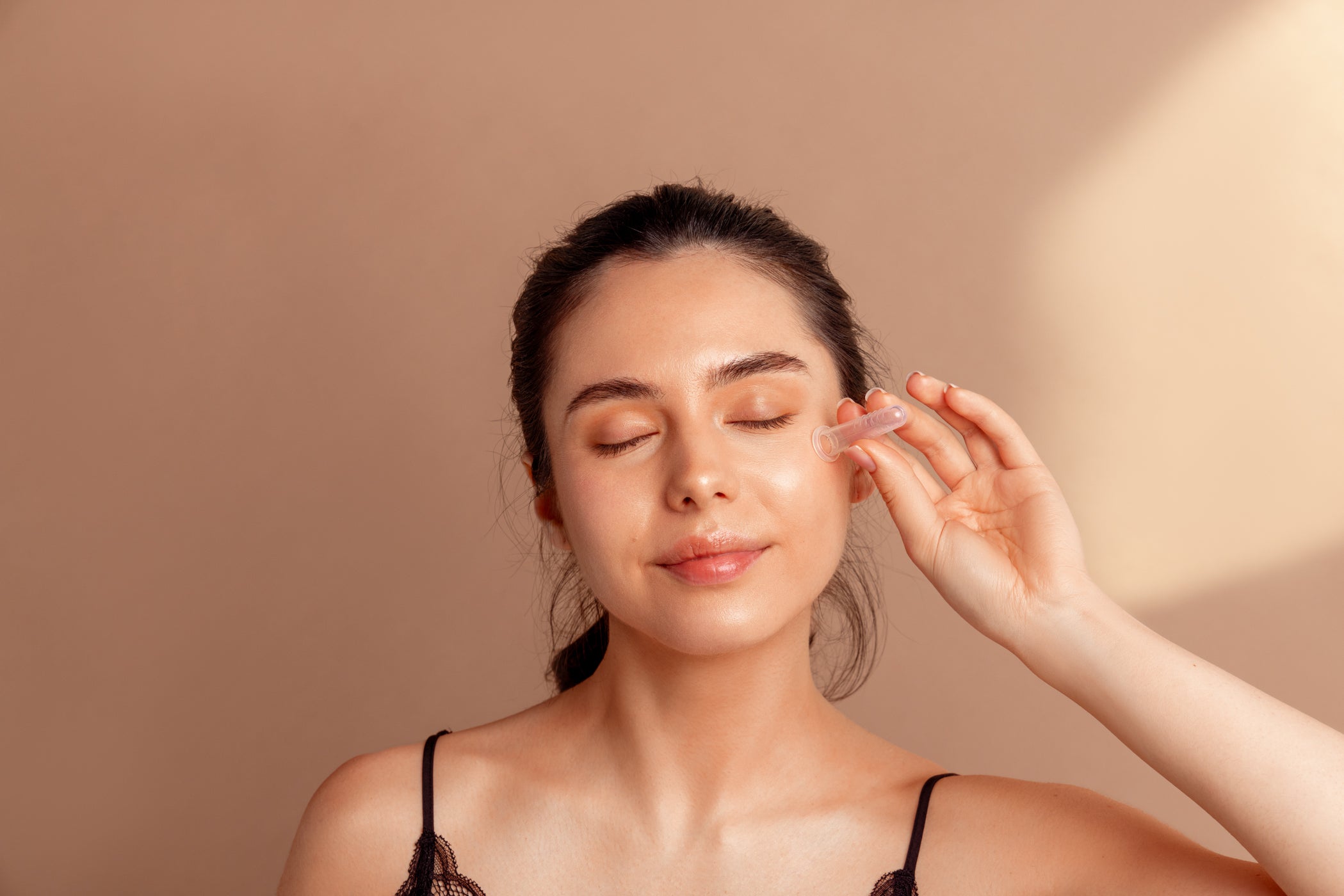 Woman applying Fasciq to promote circulation and collagen